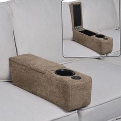 a couch with two speakers attached to it's back and the seat is made out of fabric