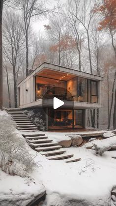 a house in the woods with snow on the ground and stairs leading up to it