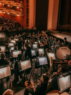 an orchestra with lots of instruments and people