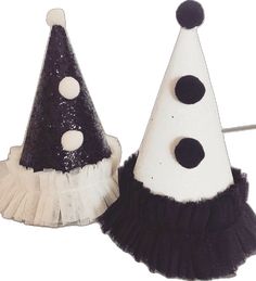 two black and white party hats with polka dots