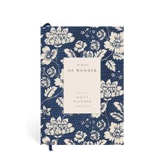 a blue and white book with flowers on it, the front cover is open to reveal an