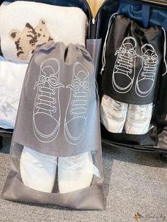 an open suitcase with two pairs of shoes on it and one pair of socks in the bag