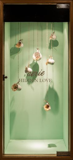 a display case with seashells hanging from it's sides and the words imagine hidden love