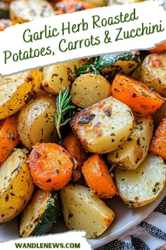 garlic herb roasted potatoes, carrots and zucchini in a white bowl on a table