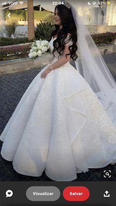 a woman in a wedding dress is taking a selfie with her cell phone screen