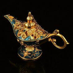 a gold and blue teapot on a black surface