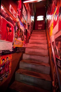 the stairs are covered with posters and pictures