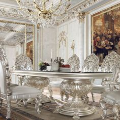 a dining room table with chairs and a chandelier