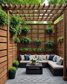 an outdoor living area with couches and potted plants