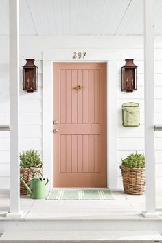 a pink front door on a white house