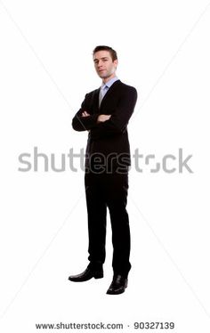 a man in a suit and tie standing with his arms crossed, looking at the camera