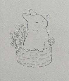 a drawing of a bunny in a basket with flowers