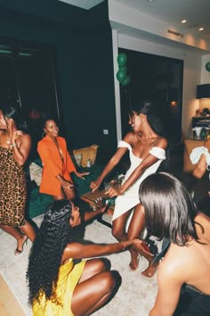 group of women sitting on the floor playing with each other