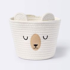 a white basket with a bear face on it