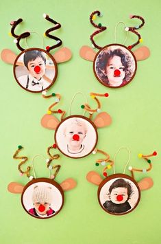 four christmas ornaments with pictures of clowns and reindeer noses hanging from strings on a green background