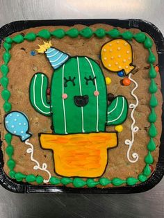 a cookie decorated like a cactus in a pot