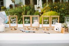 the table is set up with place cards and other items for guests to write on