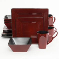 a red dinnerware set with matching cups and saucers is displayed on a white background