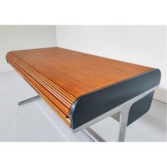 a wooden table sitting on top of a white floor