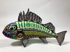 a colorful fish sculpture sitting on top of a white table