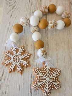 an assortment of cookies and decorations on a wooden table, including snowflakes