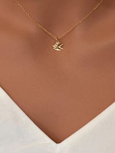 14k real gold flying bird necklace. Delicate Dove Bird Necklace.  A 14k gold sparrow necklace would make a beautiful and symbolic addition to your collection, representing freedom, hope, and love. Perfect for everyday wear or as a meaningful gift, this necklace combines timeless style with rich symbolism. All components onto 14k solid gold (not gold fill or gold plated) It consists of ... -14k solid gold 12.3 x 9.2mm bird pendant charm attaches  onto  -14k solid gold cable chain , rope chain or Sparrow Necklace, Peace Jewelry, Dove Bird, Flying Bird, Tiny Bird, Peace Dove, Bird Necklace, Bird Pendant, Bird Jewelry