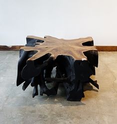 a wooden table made out of logs on the floor