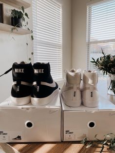 two pairs of nike shoes are on top of boxes