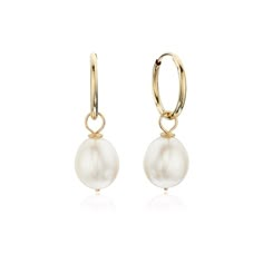 These beautiful large gold pearl drop hoop earrings are a classy addition to any outfit, especially a wedding dress! Made purely with 9ct gold and a large freshwater pearl, our pearl drop earrings are the perfect jewellery gift for a bride! Our pearl earrings are handmade in our London studio. To keep your jewellery shining bright, we recommend giving it a little care over time. By using a soft, lint-free jewellery cloth, you can remove blemishes that result from body oils, perfumes and lotions, whilst protecting the finish on your beautiful Lily & Roo jewellery from future damage.  TOP TIPS Avoid the five S's - Sleep, Shower, Swim, Sprays (perfumes) & Sweat (exercise).  Always ensure you fasten up your necklaces and store each piece individually in a cool, dry and dark place, to help prev Drop Hoop Earrings, Pearl Jewelry Wedding, A Wedding Dress, Freshwater Pearls Earrings, Jewellery Gift, Diamond Fashion, Earrings Collection, Pearl Drop Earrings, Gold Pearl