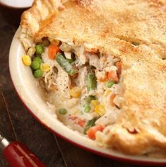 a chicken pot pie with peas and carrots