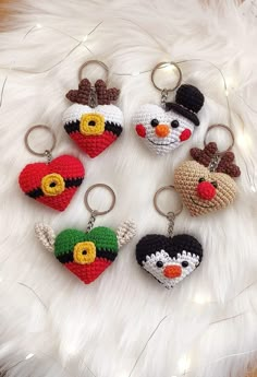 six crocheted keychains are arranged in the shape of heart shaped animals