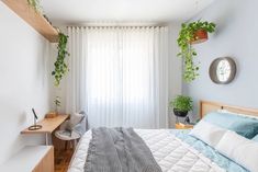 a bedroom with a bed and plants on the wall