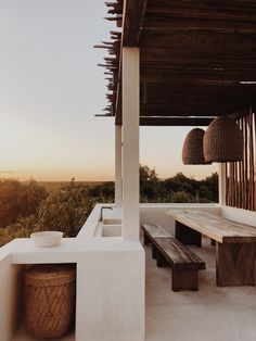 a wooden bench sitting on top of a white building