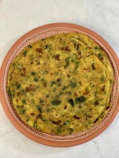 an omelet is in a bowl on a white counter top with a pink border around it