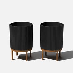 two black planters sitting next to each other