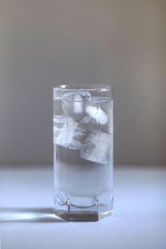 a clear glass filled with water and ice