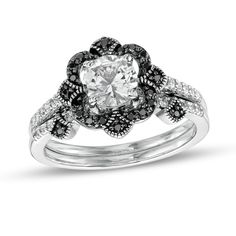 Display your unique romance with this eye-catching bridal set. Fashioned in sterling silver, the tiara-inspired engagement ring showcases a 6.0mm shimmering white lab-created sapphire. Quartets of black enhanced diamonds surround the center stone while single black enhanced diamonds in milgrain-lined frames adorn the compass points. Dainty white lab-created sapphires glisten along the shank. The wedding band features black enhanced diamonds in coordinating milgrain-detailed frames and a white la The Compass, White Lab, Forest Theme, Peoples Jewellers, Black Diamond Ring, Theme Wedding, Bridal Tiara, Sapphire Stone, Gemstone Engagement Rings