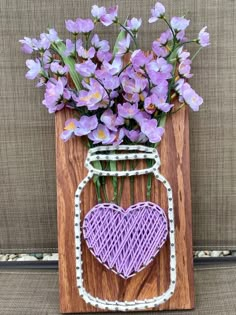 This beautiful LAVENDER string art Mason Jar vase is a great way to display faux flowers.  This piece can be a perfect gift for a special lady in your life or for Mother's Day or just a spring time fixture to decorate the home.  

It measures approximately 14" tall by 7" wide and is made from pine wood.  

Flower choices and yarn color can be specified by color.  I can do my best to match to what fits your need.  Please just message me and I will work with you. Mother’s Day Wood Craft, Spring Wood Craft Ideas, Art And Craft Ideas For Adults Creative, Easy String Art Patterns, Hanging Flower Bouquet, String Art Flower, Mason Jar String Art, فن الرسم بالمسامير, Nail And String Art