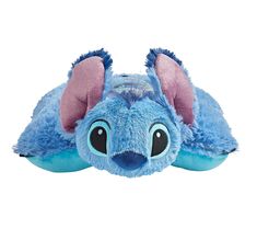 a blue stuffed animal laying on top of it's back with its eyes closed