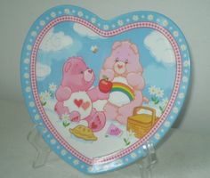 there is a heart shaped plate with two bears on it