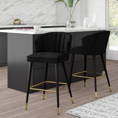 two black bar stools sitting in front of a kitchen island with marble counter tops