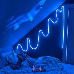 a bed in a room with blue lights on the wall