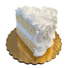 a piece of cake with white frosting on a gold plated serving platter