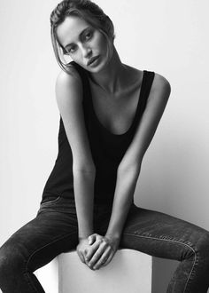 a woman sitting on top of a white box