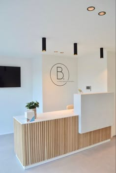 the reception area is clean and ready for customers to use in this modern, white office