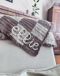 two crocheted pillows sitting on top of a couch