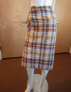 "Such a classic skirt from the mid-to-late '60s in a lightweight plaid cotton fabric! There is a pocket on the right hip on the seam; a fake flap pocket rests atop this area. On the left hip, there is a zipper and round wooden button closure. At the bottom of the skirt, there are vents on the left and right calves where the fabric is pleated, allowing ample room for walking since it's a midi skirt. Fabric: lightweight cotton Brand: Sirotto Sport Condition: good condition, no stains or holes, but could use a good steaming, there are tiny snags (only visible waaay up close) and the thread around the button started to unravel so I reinforced it Measurements: Waist: 12.5\" Hips: 17\" length: 27.5\"" Plaid Cotton Lined Skirt Bottoms, Spring Plaid Pencil Skirt, Fall Cotton Knee-length Pencil Skirt, Plaid Pencil Skirt For Spring, Plaid Pencil Skirt For Spring Season, Cotton Lined Pencil Skirt For Fall, Fall Cotton Lined Pencil Skirt, Plaid Cotton Skirt For Work, Fitted Cotton Plaid Skirt