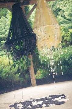 two umbrellas hanging from a wooden structure