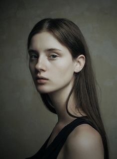 a woman with long hair is posing for a photo