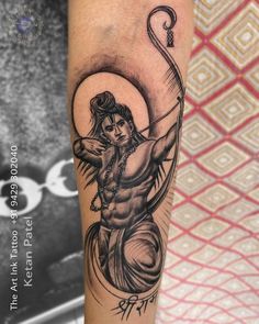 a tattoo on the arm of a man with an arrow